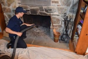 Chimney Worker Cleaning the fireplace