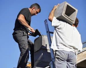 Chimney Workers On The Roof
