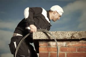 Chimney Worker On Roof