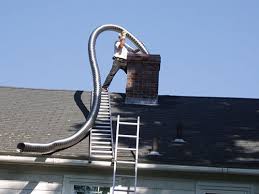 Man installing a new chimney liner into chimney