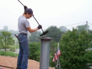 Man with chimney brush